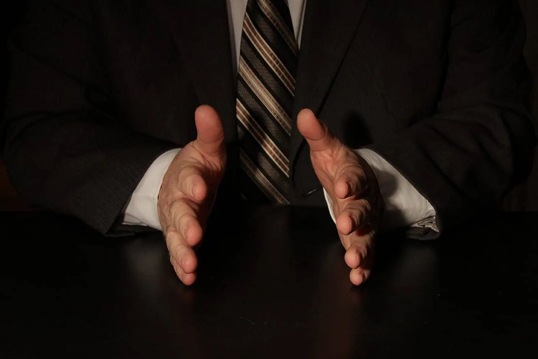The Importance of Hands in Communication (Part Two) 4 Hands of a man in a suit placed face to face on a black table